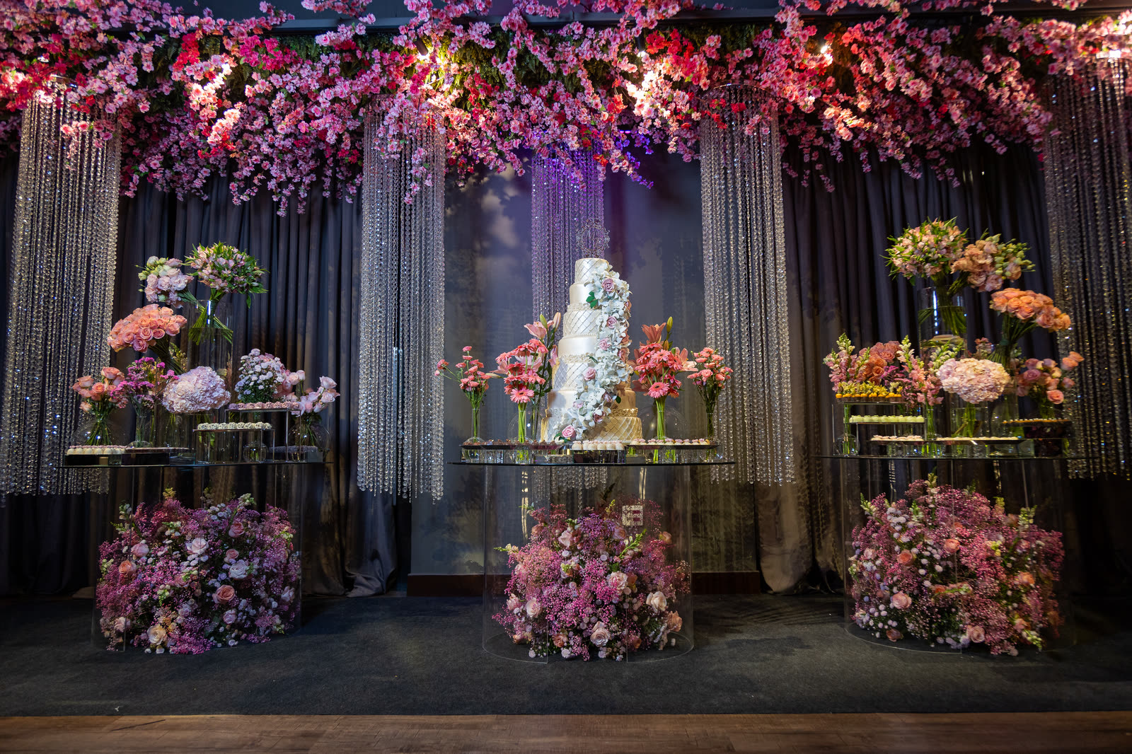 Cake table with flowers and crystal curtains